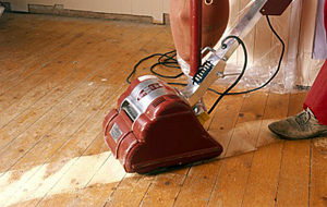 Man drilling a hole in a ceiling