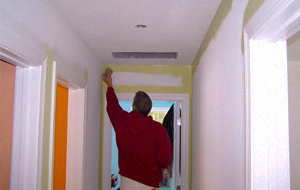 Man drilling a hole in a ceiling