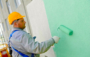 Man drilling a hole in a ceiling